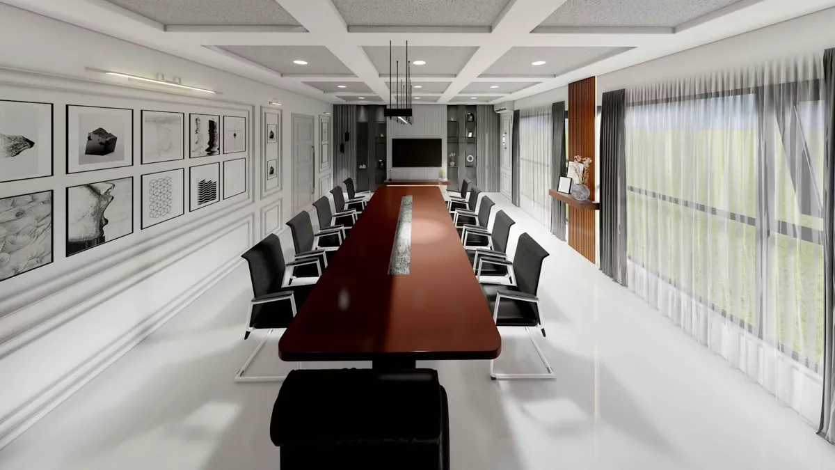 Sala riunioni luminosa con lungo tavolo e sedie nere